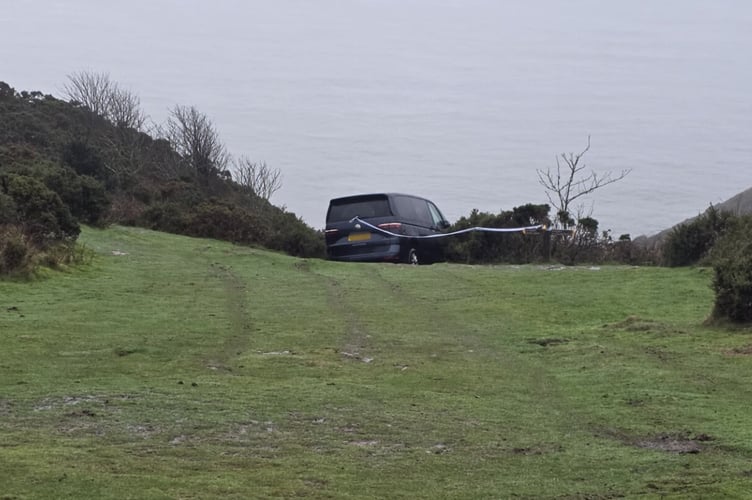 The VW camper van stuck above cliffs on Exmoor.