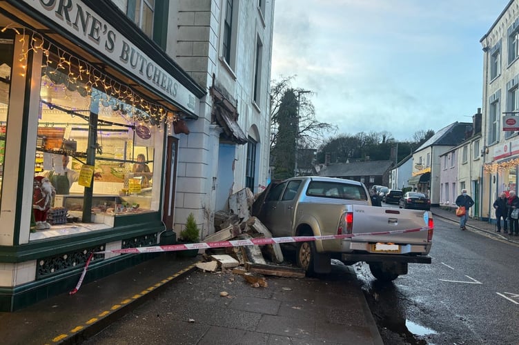 A crashed vehicle can be seen embedded in the front of a Wiveliscombe  house on Thursday.