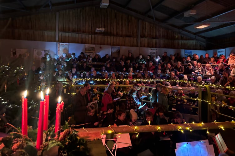 Farming families pack the auction ring of Cutcombe Market for the annual 'Singing in the Ring' carol service.