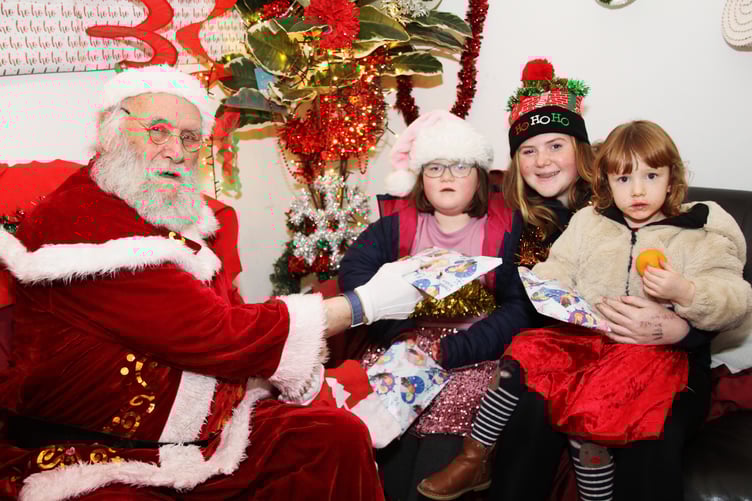Santa meets Annie and Elizabeth Muirhead and Becky Cottrell. at Doniford Farm Park's Christmas bazaar.