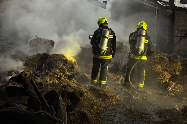 A Devon and Somerset Fire and Rescue crew dealing with a previous barn fire.
