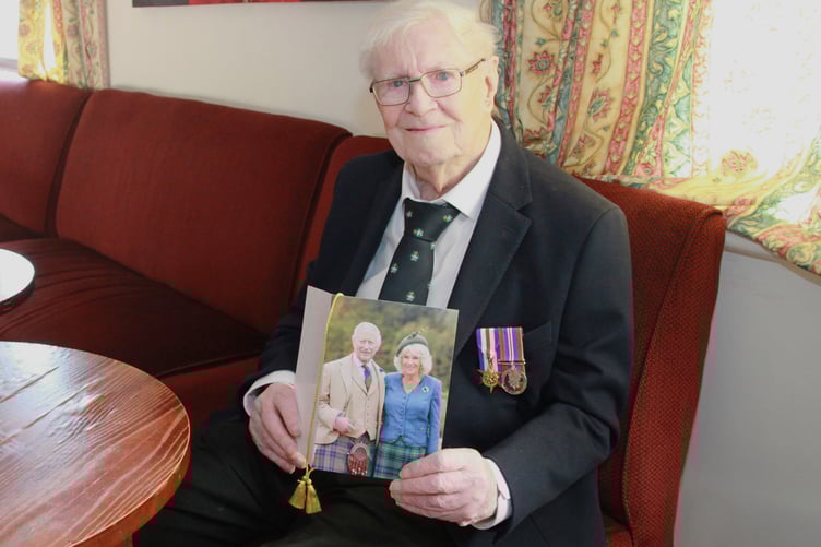 Proudly displaying his 100th birthday card from the King and Queen is war veteran George Lewis, of Watchet.