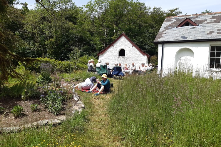 Volunteers relaxing on Exmoor with tea after a session restoring the Ashcombe Garden and White Rock Cottage site.