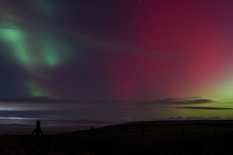 Stars twinkling through the Northern Lights.
