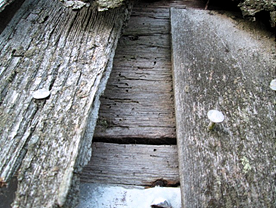 Rotting timbers with nails coming loose inside the tower of St Dubricius Church,Porlock.
