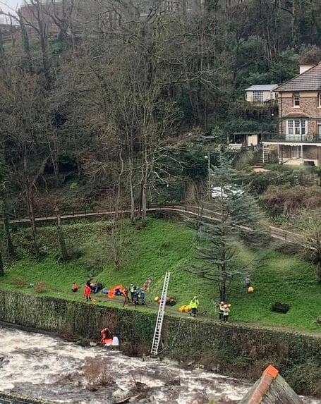 The dramatic scene as emergency services work to rescue a woman from an Exmoor river.