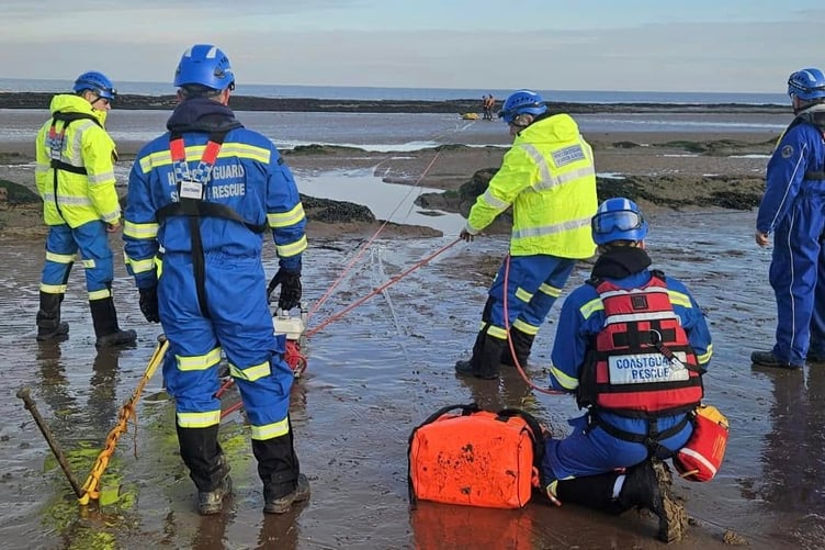Coastguards on a mud rescue training exercise.