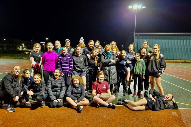 Minehead rugby girls face the camera with MP Rachel Gilmour 

