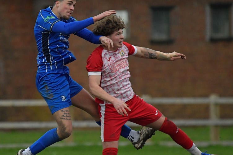JJ Knight (in blue) who scored for Minehead in their big win over Clutton in November 
