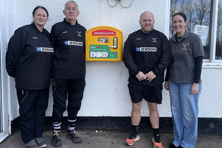 Pictured with the new Minehead defibrillator are (left to right) rugby club life members Faye and Graham Symes, club chairman James Baker, and rugby safe lead Sarah Penny.