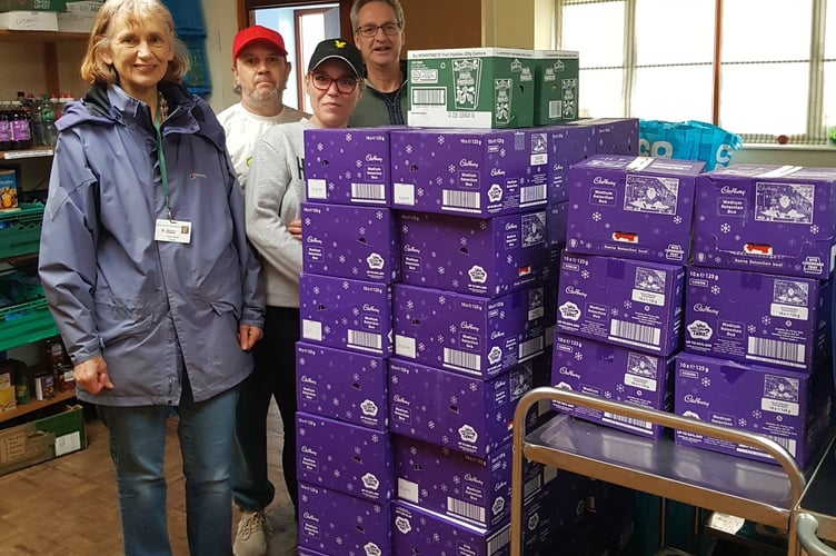 West Somerset Food Cupboard volunteers with Christmas chocolates given by Butlin's.
