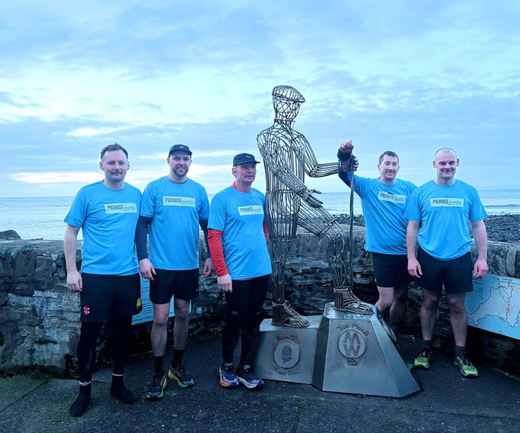 The Coleridge Way five with the Two Moors Way statue at their finishing point in Lynmouth.