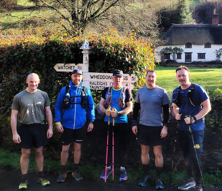 The five runners (left to right) Ollie Claydon, Brandon Walsh, Kev Liddle, Tom Potter, and Connor Jeromson stop for refreshments in Luxborough.
