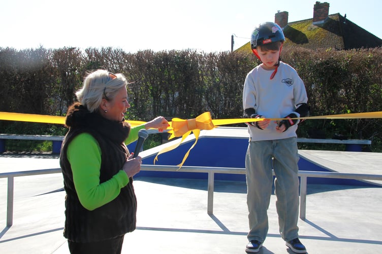 Twelve-year-old Jack Jukes is helped by West Somerset MP Rachel Gilmour to cut a ribbon to declare open the town's new wheeled park.