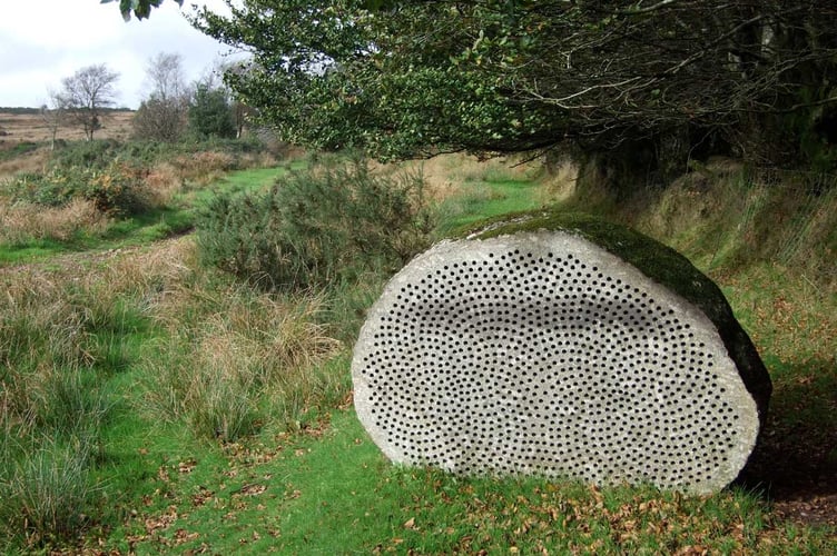 Two halves of an inscribed granite boulder sit facing each other on the edges of Dartmoor and Exmoor in memory of Joe Turner, whose brainchild the Two Moors Way was.