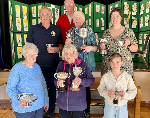 Malcolm Appleton (rear) who presented Porlock Horticultural and Craft Society spring show 2026 cups to (left to right) middle row - Chris Yates, Sue Appleton, Catherine Greer, front - Christine Miles, Caroline Lister, Chloe Denton.