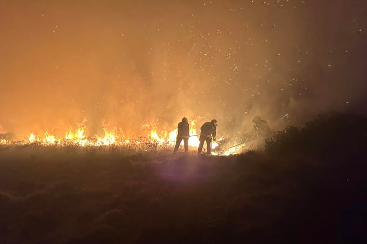 Firefighters tackle a blaze started by an arsonist on the edge of Exmoor on Monday night.