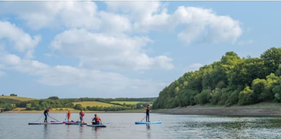 Paddle boarding on Wimbleball Lake, Exmoor.