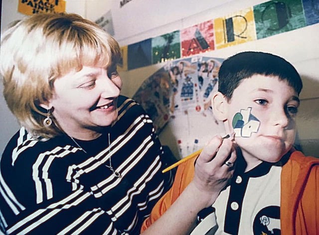 Lauren Staton in the early days of Snazaroo tries out face paint on her young son Joe.