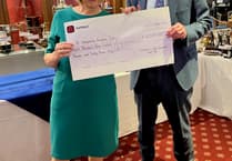 Cheque for nearly £10,000 presented to hospice by golf club