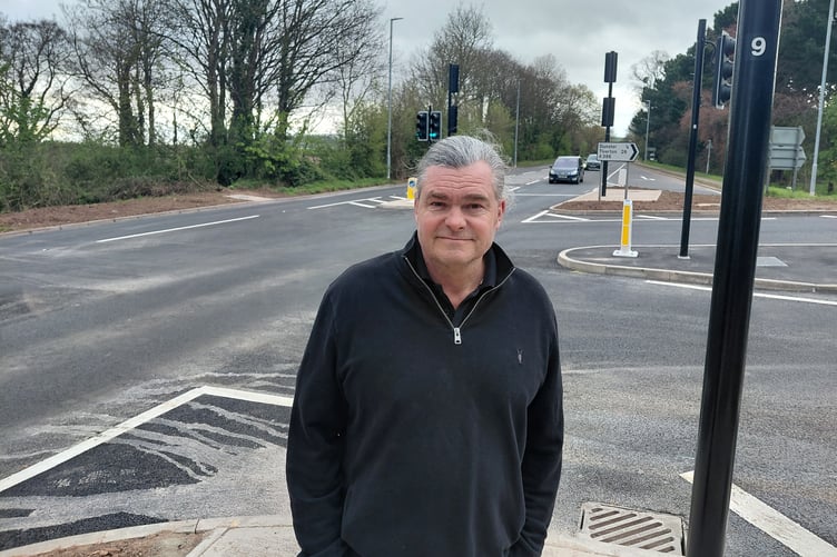 Somerset Cllr Marcus Kravis with the new Dunster Steep traffic lights on the A39.