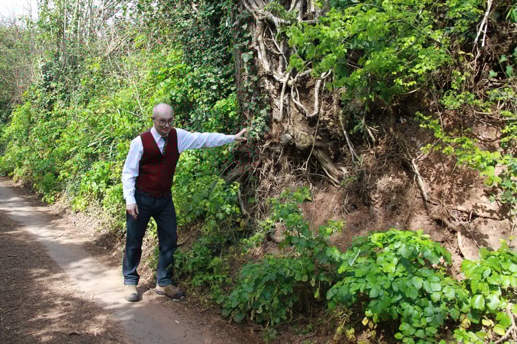 Campaigner Chris Gates shows damage caused by erosion in Minehead's Periton Lane. PHOTO: George Ody.