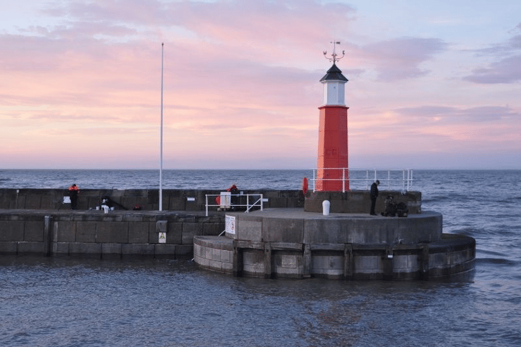 Watchet Lighthouse has to be repainted in green to meet maritime safety regulations.