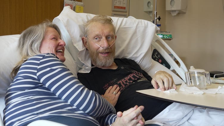 Angie and Robin Churchill using a cuddle bed in St Margaret's Hospice.