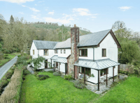 Idyllic property for sale with stream bordered gardens