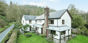 Idyllic property for sale with stream bordered gardens