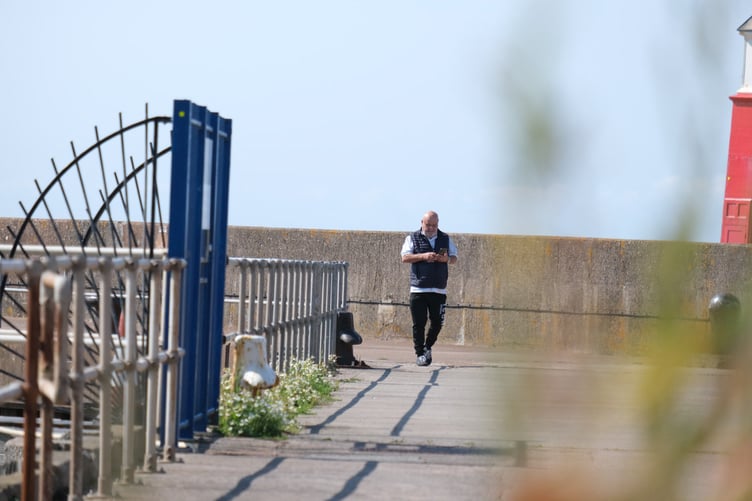 Colin Benson captured on film by NCA officers walking next to Watchet Marina.