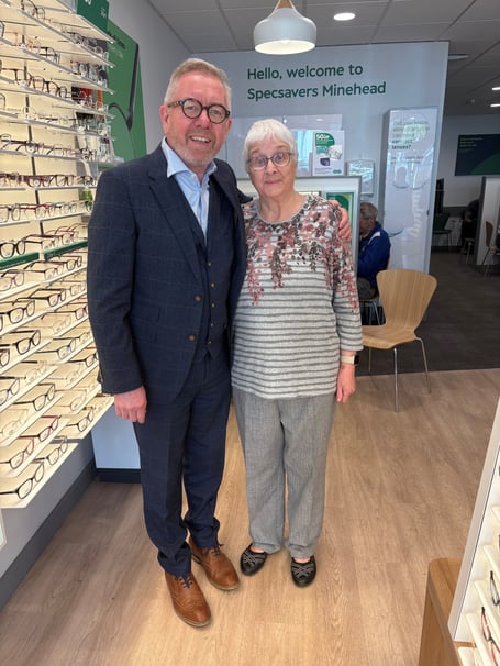 Eye patient Christine Herring with Minehead optician Paul Bradford, who saved her life with his quick GP referral.