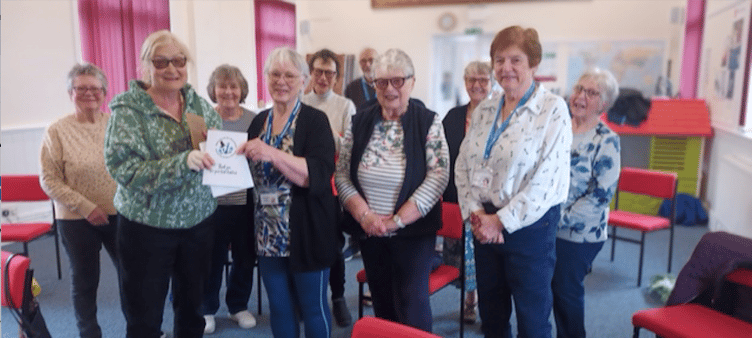 Flexercize class leader Shirley Allnutt presents the donation to Margaret Tatham (left).