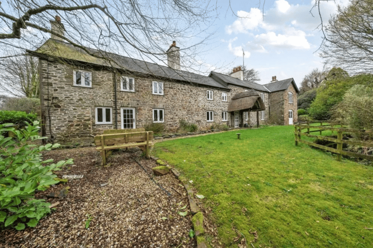 Henspark is approached over a sweeping driveway leading to the house, stables and parking