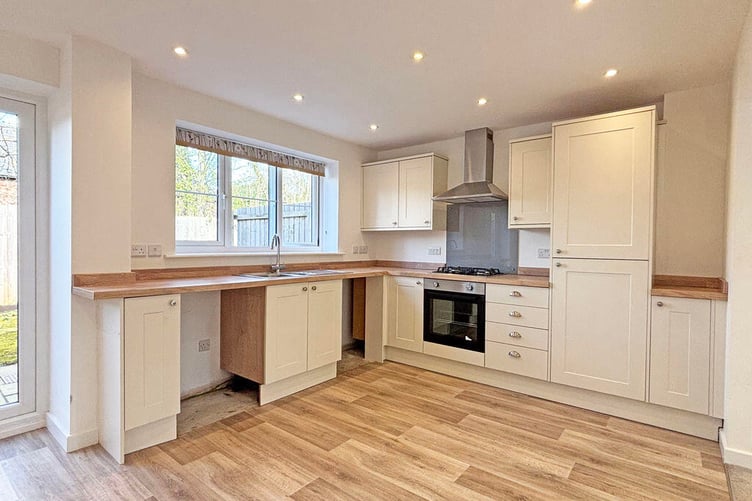 There is space for a dining table and chairs in the kitchen area