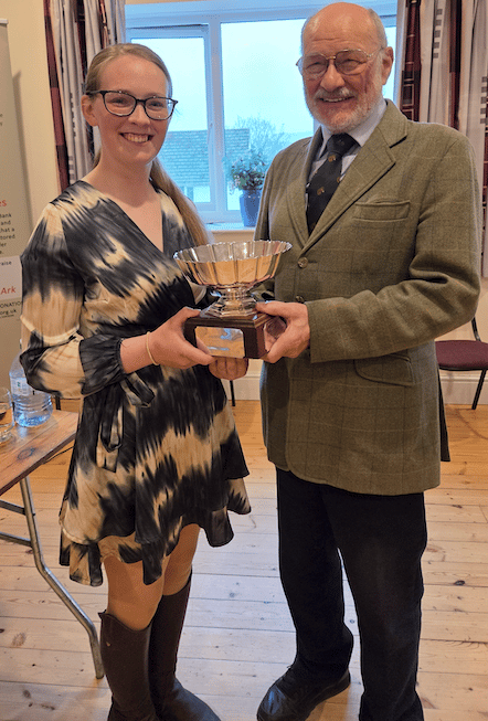 Megan Gillon is presented with the Jan Price Cup by the Exmoor Pony Society's Ian Graham.