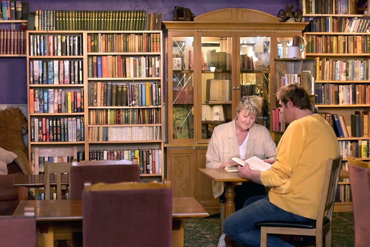 Carhampton's Butchers Arms pub has added a community library for the village. PHOTO: Nina Dodd.