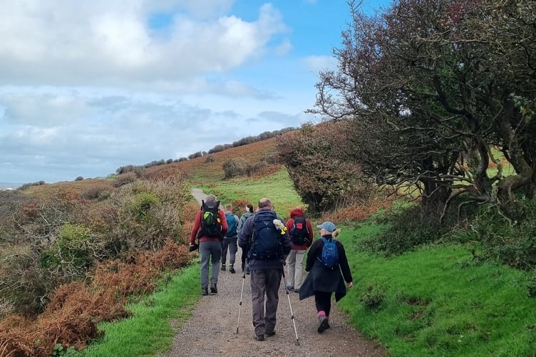 A group walking the King Charles England Coast Path through West Somerset.