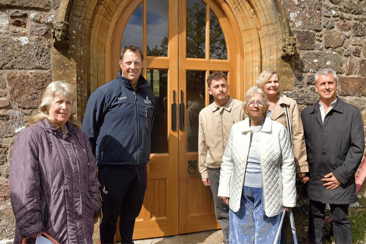 Somerset cricketer Marcus Trescothick with members of Harold Gimblett's family outside the Bicknoller church's new doors.