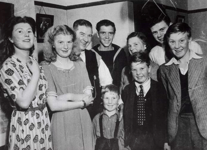 Ernie Munson (centre) pictured on his homecoming from the Navy.