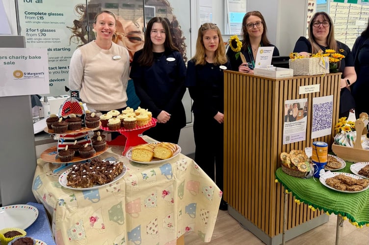 Staff at Specsavers, Minehead, with some of the cakes they sold for hospice funds.