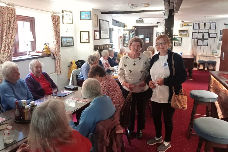 Margaret Tatham (left) of Watchet's Forget Me Not Cafe, with Hilary Mills, of Roadwater's Ladies that Lunch, and some of the ladies.