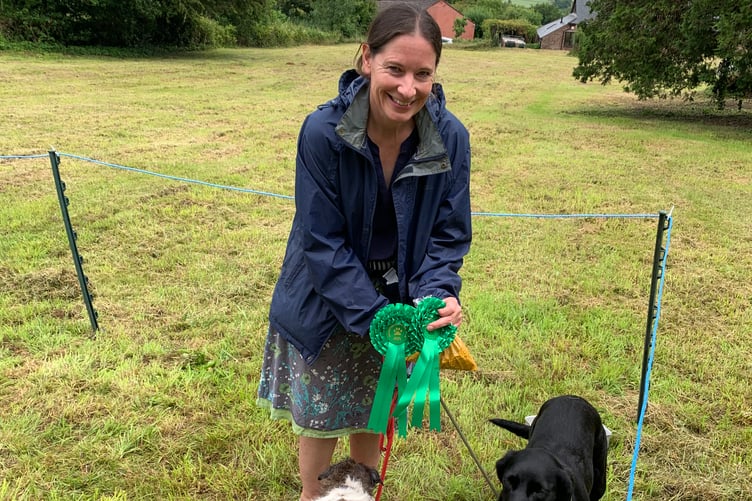 Camera shy Nellie the Jack Russell and Pip the Black Labrador, with owner Clare Mowat at last year’s dog show.