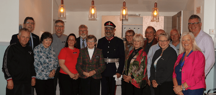 Somerset's Lord Lieutenant Mohammed Saddiq is flanked by Exmoor Community Bus Association volunteers past and present for the presentation of the King's Award for Voluntary Service.