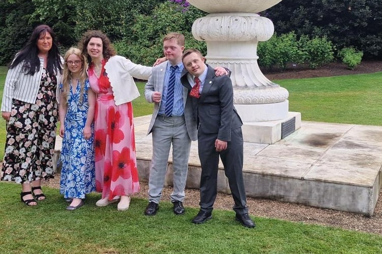 Minehead Aurora Foxes house manager Nina Patrick with students Arianna, Ella, Alex, and Ben at Buckingham Palace.