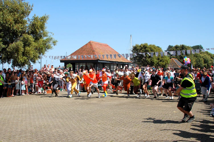 Out of the starting blocks toward the first pit stop of the annual Watchet wheelbarrow race. PHOTO: George Ody.