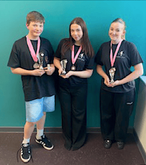 Young dancers Ethan Williams, Lola-Rae Jeff, and Olivia Cole returned to Minehead with several awards after a successful regional competition in Bristol.
