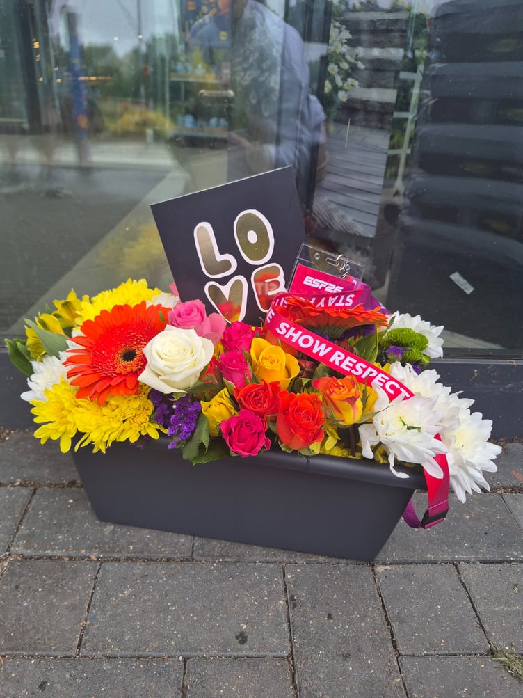 Floral tributes to Kamil Mroz, who was found dead near the Lidl supermarket in Minehead.