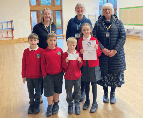 Pauline Takle presented a cheque from Xmoor-Rox to All Saints and Dulverton School.