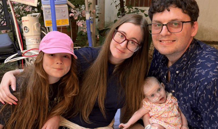 Baby Maddison-Grace with her sister Holly and parents Luke and Chelsea Moore.